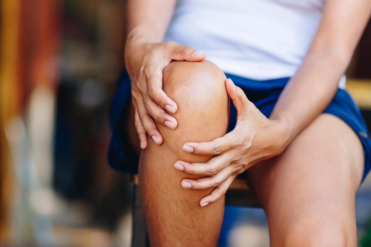 Frau hält sich Knie Schmerzen
