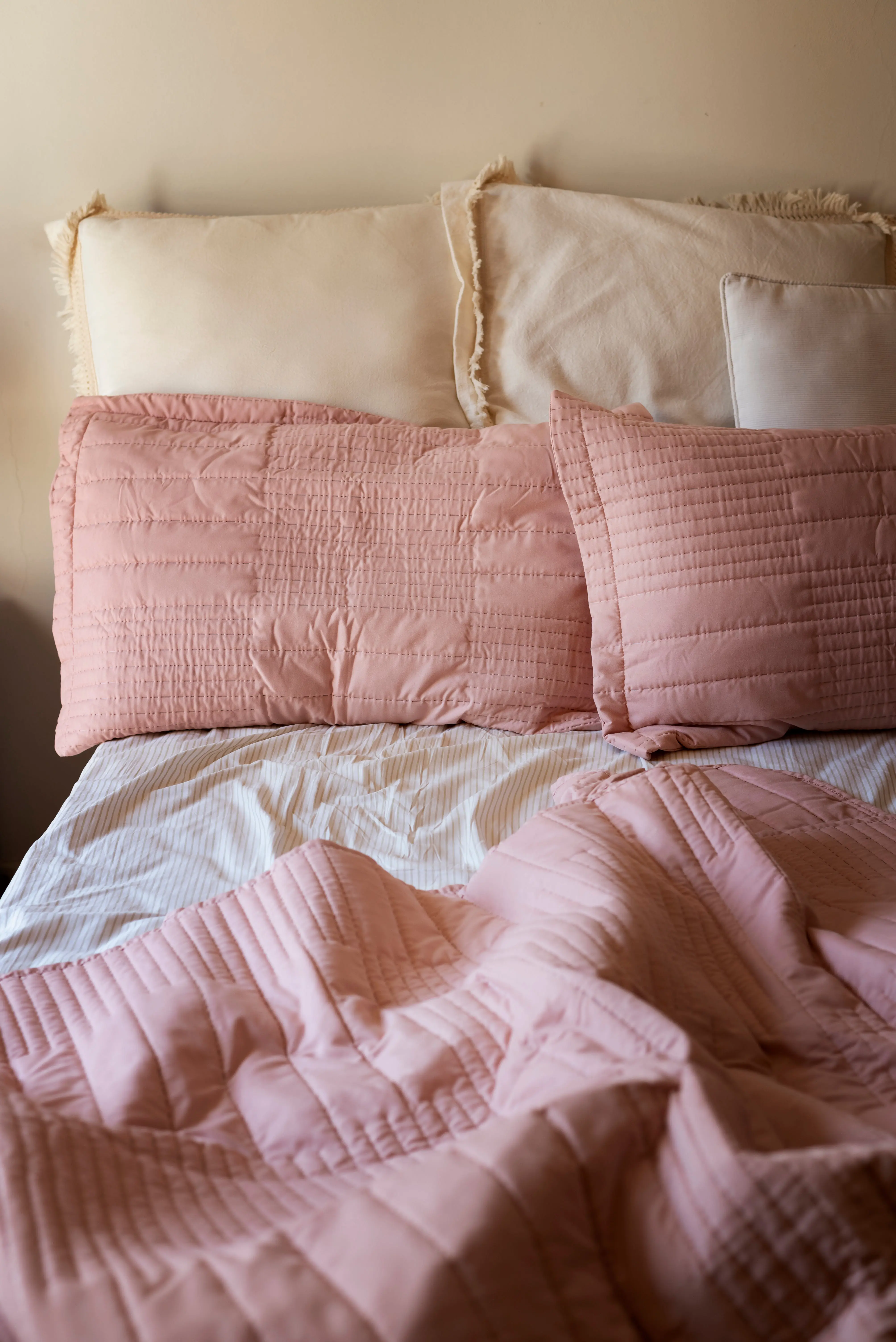 Bett mit rosa und weißen Kissen